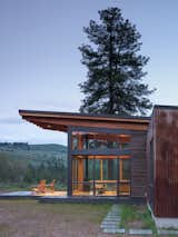 Generous overhangs help mitigate intense western light, while large multi-slide doors on either side of the main living space encourage natural ventilation.