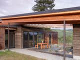 The exposed glulam beams of the roof support retractable awnings, giving the space flexibility and providing additional shade and cooling to the rest of the home.