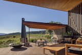 Multiple patios step down along the slope of the land.