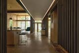Hallway and Concrete Floor The entry axis hallway connects the two main volumes of the house, and divides the program into public and private spaces.  Photo 5 of 19 in Copper Harbor by Prentiss + Balance + Wickline Architects