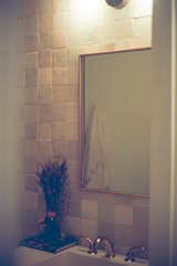 Terra-cotta tile from Clé adorns the guest bathroom. The couple gutted both bathrooms and had custom concrete countertops made for the vanities.