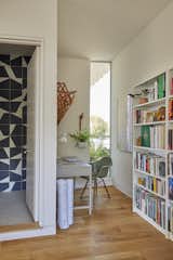 A corner of the office, which doubles as a guest bedroom, features an Ikea desk and a Henry Miller chair. The wall tile in the guest bath is from Mutina.