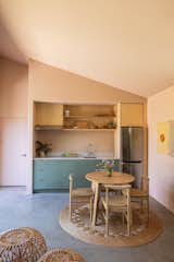 Danny fitted the kitchen into an alcove outfitted with Ikea cabinets and Semihandmade fronts. The refrigerator is by LG. On the jute rug by Armadillo, chairs from Threshold join a table from Inside Weather.
