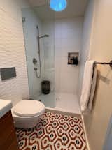 Wall and shower tile from All Natural Stone in Berkeley is paired with Artisan Tiare porcelain tile from the Tile Shop in the bathroom.  Photo 4 of 12 in The Living Is (Mostly) Easy for the Residents of Three California ADUs