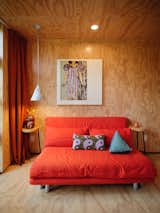 A painting by Lizz is displayed above a Ligne Roset convertible sofa in the office/guest bedroom. The pendant light is by Project Room. 