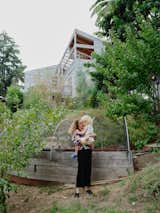 Lizz and Esphyr stand below the house in the sloping backyard, where fruit trees flourish alongside cardoons and Mexican marigolds.