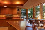 Highly detailed woodwork pairs with limestone in the kitchen and dining area.  Photo 6 of 17 in After 50 Years, a Frank Lloyd Wright Finally Got Built. Then It Spawned a Sibling.