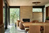 As a nod to the textured limestone at Bear Run, Sara and Jeremy chose concrete masonry blocks for both the interior and the exterior of kYodai. The club chairs are from Restoration Hardware and the windows and doors throughout are by Andersen.