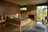 A bed and nigh tables by Willie Willette and a Frank Gehry Wiggle chair are joined by Frank Lloyd Wright lamps in the primary bedroom.