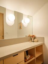 Warwas cut the ADU bathroom mirror to accommodate the Niveous sconces. “That was a fun detail that Antonio and I came up with,” he says.