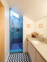 Using tiles from Daltile, Warwas designed the gradient pattern in the ADU shower. The Granada cement floor tiles are from Mission Tile. The sink and faucet are by Kohler.