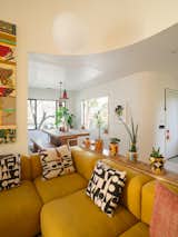 Antonio designed the console table using a zebrawood plank that once adorned the fireplace, which was removed during the renovation. In the dining area beyond, pendants by Torbjörn Vejvi hang above the Kayu teak table from Design within Reach.