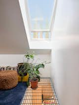 During construction, Warwas and Antonio noticed that the skylight in the sleeping loft brought abundant light into the living room, so Warwas designed an opening that allows the skylight to be used twice. An inexpensive grate by Grainger pulls air through the space as well.