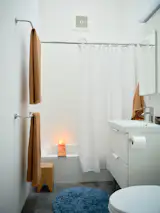 Though it's compact, the bathroom is illuminated by one of the ADU's three skylights. "The light is fantastic,