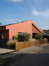 Knight combined Hardie board and wood siding on the exterior of the duplex, which consists of the ADU at left and a single-family unit at right—unifying them with Benjamin Moore's Burnt Sienna. The entrance to the ADU leads through a private patio that Hannah and Rami use year-round.