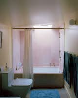 Floor-to-ceiling pink marble brings sparkle to the bathroom as well as the kitchen. "You really get that pink light here in the morning, and I tried to bring that in," he says. 