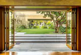 The central patio as seen from the loggia. Wright’s design featured indoor and outdoor living spaces, open-plan living areas, an outdoor sleeping porch, and cast-concrete doors weighing about 250 pounds each. Of their financial and artistic differences, Barnsdall wrote in a 1926 letter to Wright: "I hope we may not consider each other enemies, and that we may never attempt to work together again. It can’t be done. We are both too much of the same mold—egotistical, dictatorial, and creative."&nbsp;