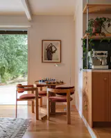 A table from a Design Within Reach Outlet is joined by vintage chairs from L.A. Modern in a corner of the living room, which now opens to the kitchen. “The floor plan really tells the story,” says architect Barbara Bestor. “It’s not not the same, but it’s differently organized.”