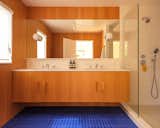 Picking up on shades of blue used elsewhere, a blue cement tile from Zia Tile brightens the primary bathroom. The shower is lined with tile from Daltile.