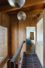 Holophane globes from Pooky Lighting hang in the updated hall.