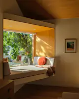 Warwas set the bump-out at an angle, to capture the tree canopy throughout the year. It's outfitted with automatic shades for privacy.