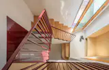 “The coupling of the solid wood lower portion of the stair with the perforated upper run connects the upper and lower levels with the entry and permits views between spaces and brief moments of delight,” Mitanidis says.