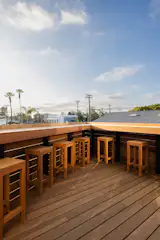 Teak stools from Patio Productions San Diego provide seating for groups on the triangular deck.