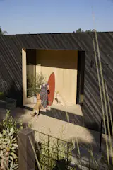 Ruth stands near the rear entrance of the second floor with the couple's English Labs, Toffee and Rolo. "This house is a giant dog run,