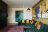 Scott furnished the white oak–accented media room with a B&B Italia Tufty-Time sofa designed by Patricia Urquiola, a Lawrence of La Brea rug and an Artemide Tolomeo XXL floor lamp.