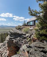 Outdoor, Trees, Boulders, Slope, and Woodland  Photo 4 of 9 in Two Connected Cabins Make Up This Spectacular Retreat in Colorado from Big Cabin | Little Cabin