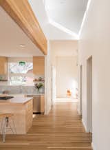 Kitchen, Marble Counter, Wood Cabinet, Medium Hardwood Floor, Stone Slab Backsplashe, Pendant Lighting, and Drop In Sink  Photo 4 of 4 in Reduce | Reuse | Remodel by Renée del Gaudio Architecture