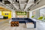 The locally-sourced reclaimed wooden wall and moss sign by Articulture bring the outdoors inside in Techspace Austin's office.