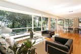 Living Room, Bench, Chair, Sofa, End Tables, Coffee Tables, Floor Lighting, and Medium Hardwood Floor  Photo 9 of 21 in An Amazing Tree-Covered Glass House For Sale in the Berkeley Hills