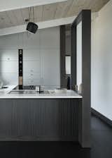 Kitchen, Cooktops, Wood Cabinet, and White Cabinet The Henrybuilt Functional Partition Wall can be freestanding, or attached to an island or peninsula.  Photo 7 of 10 in Henrybuilt’s Systems Instantly Upgrade Unused Space