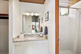Bath Room, Enclosed Shower, Undermount Sink, Granite Counter, and Wall Lighting Simply updated, the adjoining master bathroom has a bright shower and spacious walk-in closet.  Photo 21 of 23 in Check Out 2 Beautifully Renovated Eichlers For Sale in San Francisco