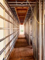 Hallway With the help of BONE Structure steel framework, electrical wires can be easily routed through pre-cut openings  Photo 7 of 7 in Dan Brunn Architecture and Dwell Break Ground on Bridge House in L.A.