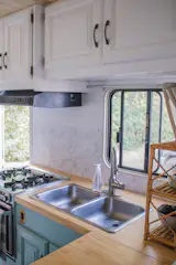 Once the old countertops were pulled out, the couple used them as a template to cut the new ones. The tile backsplash (from Home Depot) uses stick-on tile. "Real ones [tiles] have a propensity to fall off when the van hits bumps," explains Grace.

