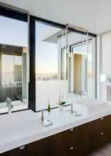 The bright master bedroom, with vessel sinks and Caesarstone counters, also enjoys sweeping city views. 