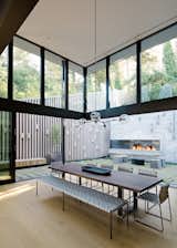 The double-height, fully glazed volume at the home's rear "brings significant light into the home, while simultaneously creating a moment to experience the verticality of the surrounding trees which loom above the home," explains Maniscalco. 