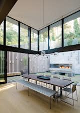 The double-height, fully glazed volume at the home's rear "brings significant light into the home, while simultaneously creating a moment to experience the verticality of the surrounding trees which loom above the home," explains Maniscalco.

