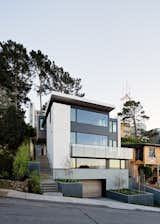 Earthy, organic materials were favored for the home's composition. The exterior palette features Pietra Serena limestone, color-integral stucco, metal panels, and stained cedar.