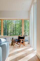 The south-facing facade, where the sun sets in the evening, is the couple’s favorite spot on the property. Creating expansive openings with this exposure allowed an intimate and inspiring connection with the wooded landscape.