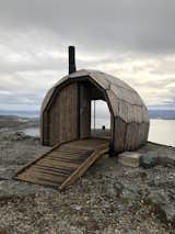 Hexagonal and pentagonal panels come together to form this cabin’s oblong envelope. The unique architectural skin mimics the rock formations that surround it.