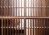 Careful detailing of the slatted screen showcases the intricate way its walnut and metal components are artfully woven together.