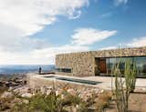 Perched high on the mountainside, the home is sited to take advantage of unobstructed views to the south of downtown El Paso and Juarez, Mexico, beyond.  Photo 2 of 11 in A Cleverly Camouflaged Family Home Floats Above the West Texas Mountainside