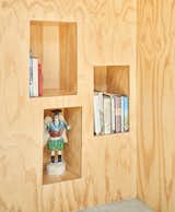 Clever under-stair recessed display nooks allow the homeowners to beautifully showcase books and objects.