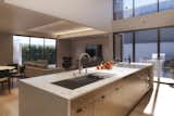the kitchen floats in a halo of natural light that filters down from the two-story volume above.  Photo 6 of 9 in Community-Minded Living and Sustainable Design Converge in Phoenix from Karma by Boyer Vertical