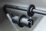 A low-flow wall-mounted faucet from VOLA moderates water consumption in the bathroom.