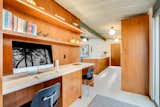 Office A new office nook just off the kitchen is positioned steps away from sliding doors that lead to the side terrace.  Photo 7 of 14 in This Meticulously Restored Eichler in the Bay Area Could Be Yours for $1.25M
