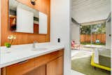 Bath Room The renovated bathrooms include custom mahogany vanities and Corian countertops.  Photo 9 of 14 in This Meticulously Restored Eichler in the Bay Area Could Be Yours for $1.25M